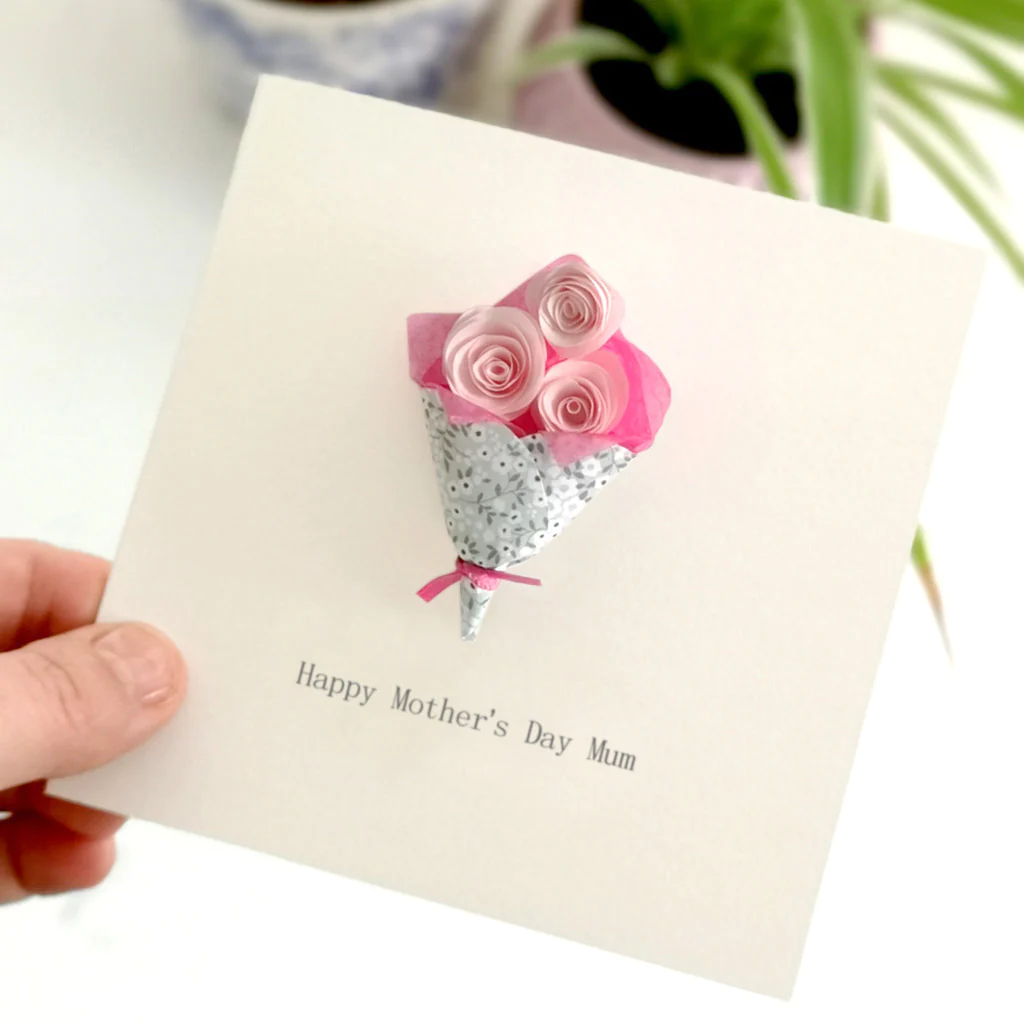 Construct a charming card by crafting colourful paper flowers and arranging them into a bouquet design