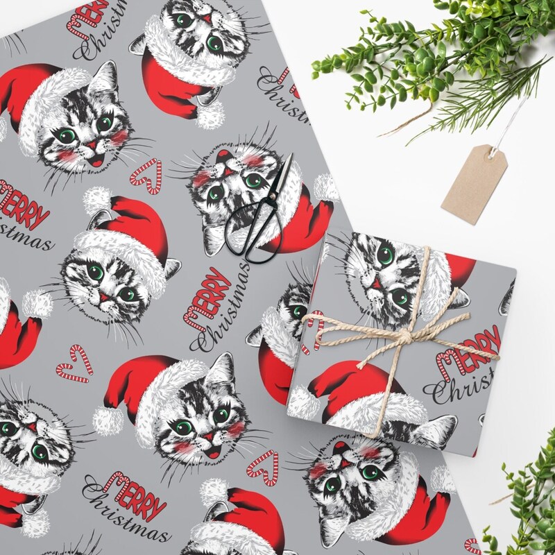 Get into the holiday spirit with gift wrap featuring cats wearing Santa hats and tiny "Meow-y Christmas" messages